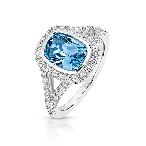 HALO STYLE RING WITH SPLIT SHOULDERS 9X7MM PALE BLUE CUSHION CENTRE